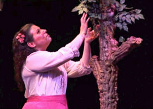 Marie admires a tree in the Orchard.